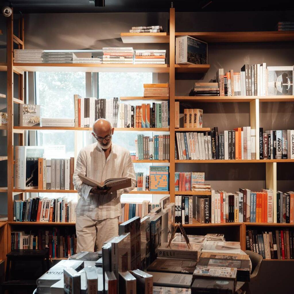 Man reading a book in library